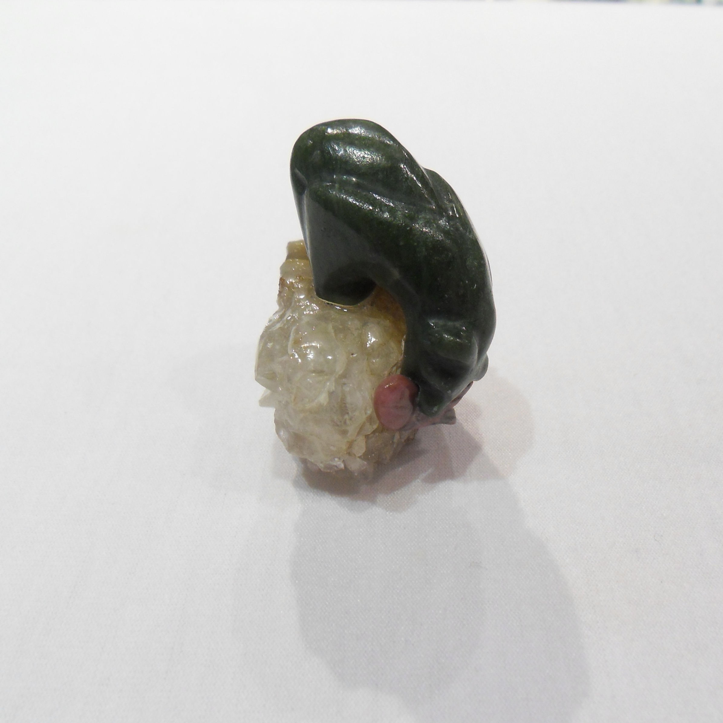 Jade Bear statue with rhodonite fish in mouth while fishing on quartz geode