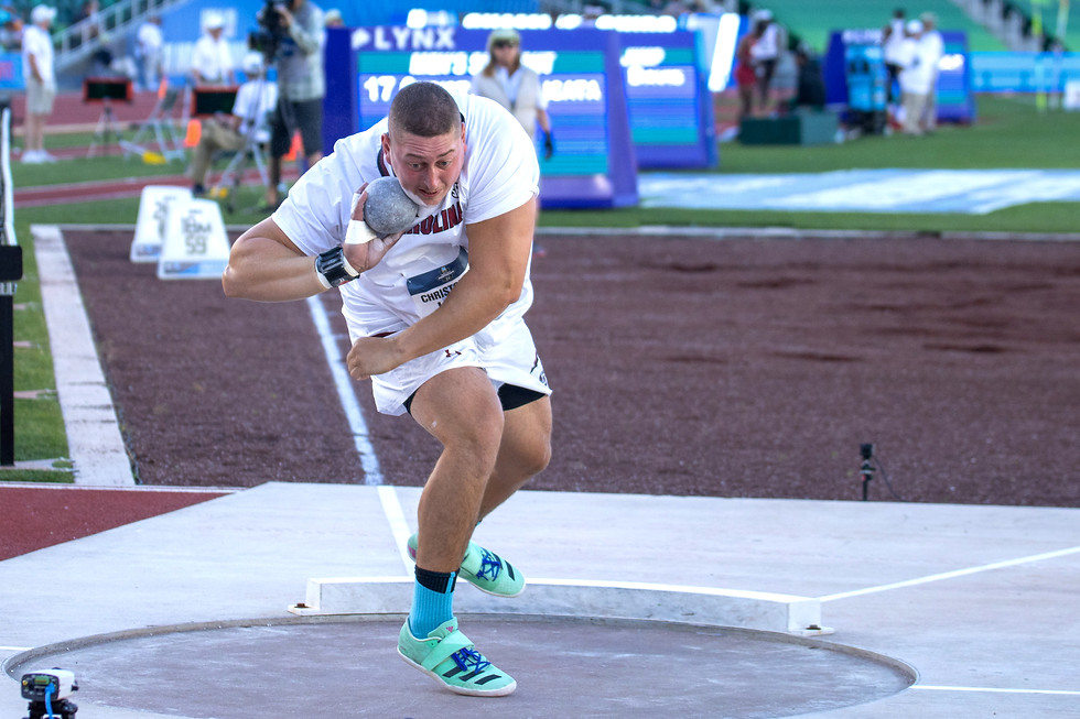 CJ Licata mid discus throw during competition - New Jersey discus and shot put coaching