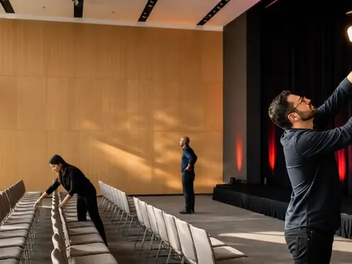 Event production team preparing a university lecture hall before an education conference.