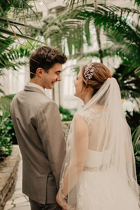bride and groom surrounded by plants_edi
