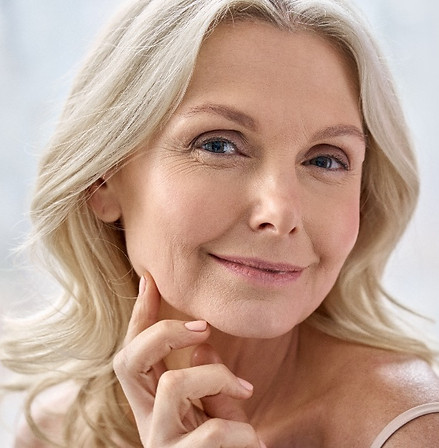 Smiling happy attractive 50s womanmiddle aged after using LED Light Therapy at Proactive