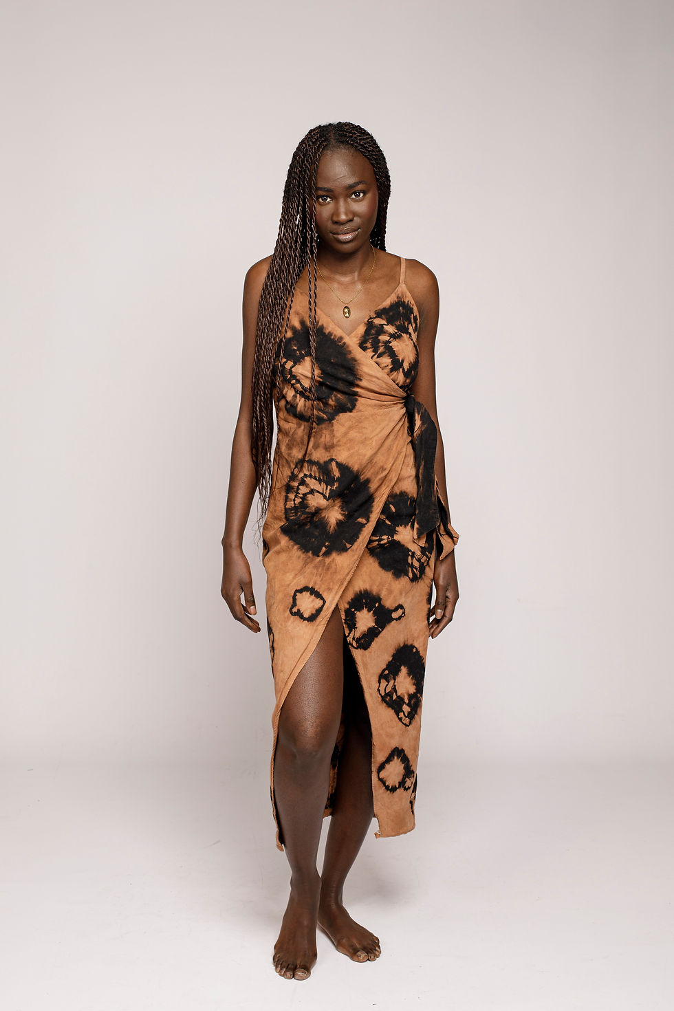 Highcycled orange and black midi dress by NYIANSU, bleached with the traditional Adire Oniko resist-dye technique.