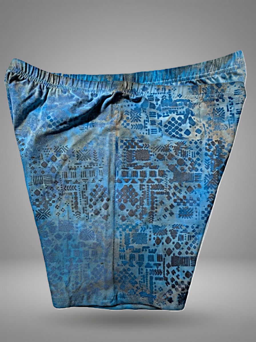 Thumbnail: Aura Blue Ritual Shorts by Nyiansu, highcycled thanks to Adire technique and Bogolan inspired metallic symbols.
