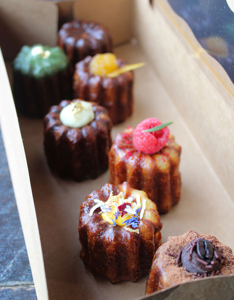 Takeout box of seven different types of Canalés