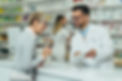 Pharmacist talking to woman at pharmacy counter