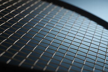 Close up image of strung tennis racquet.