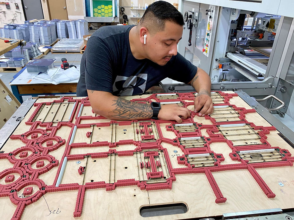 Adjusting the cutting die on the Bobst machine at the start of a printed box production run
