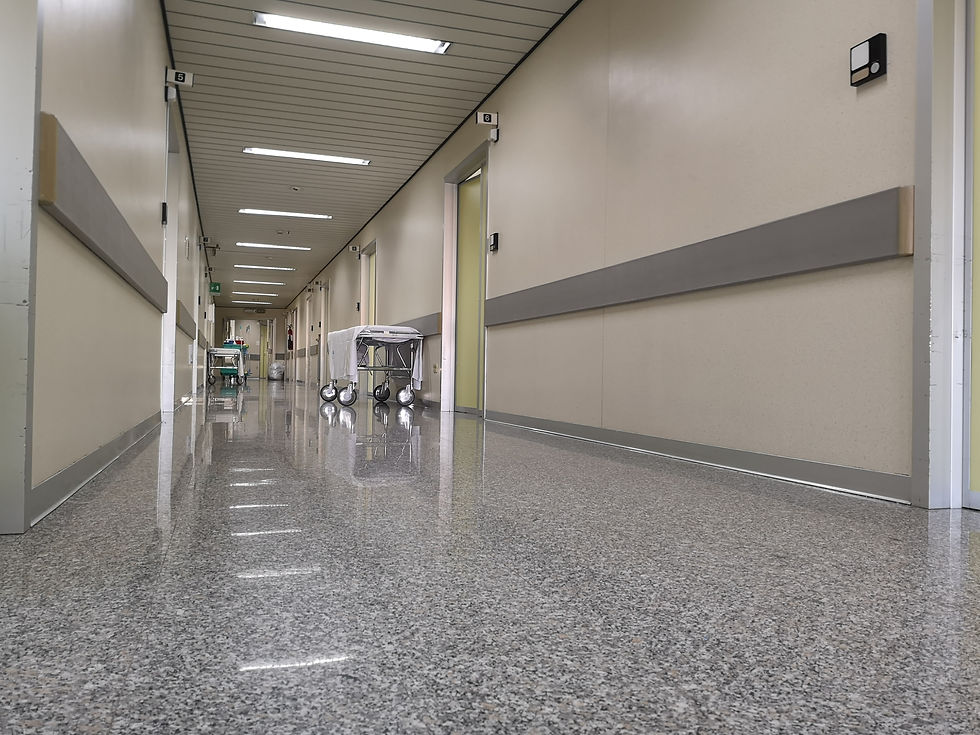 Highly polished gray granite flooring in hospital hallway