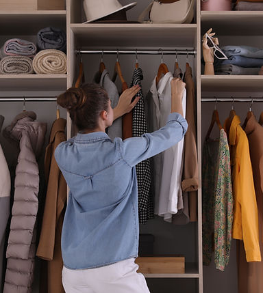 young-woman-choosing-clothes-wardrobe-closet-back-view.jpg