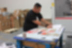 Operator giving the first die cut custom product boxes a once-over