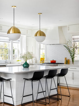 White kitchen island with brass pendants and black bar stools. Interior design Edinburgh & East Lothian.