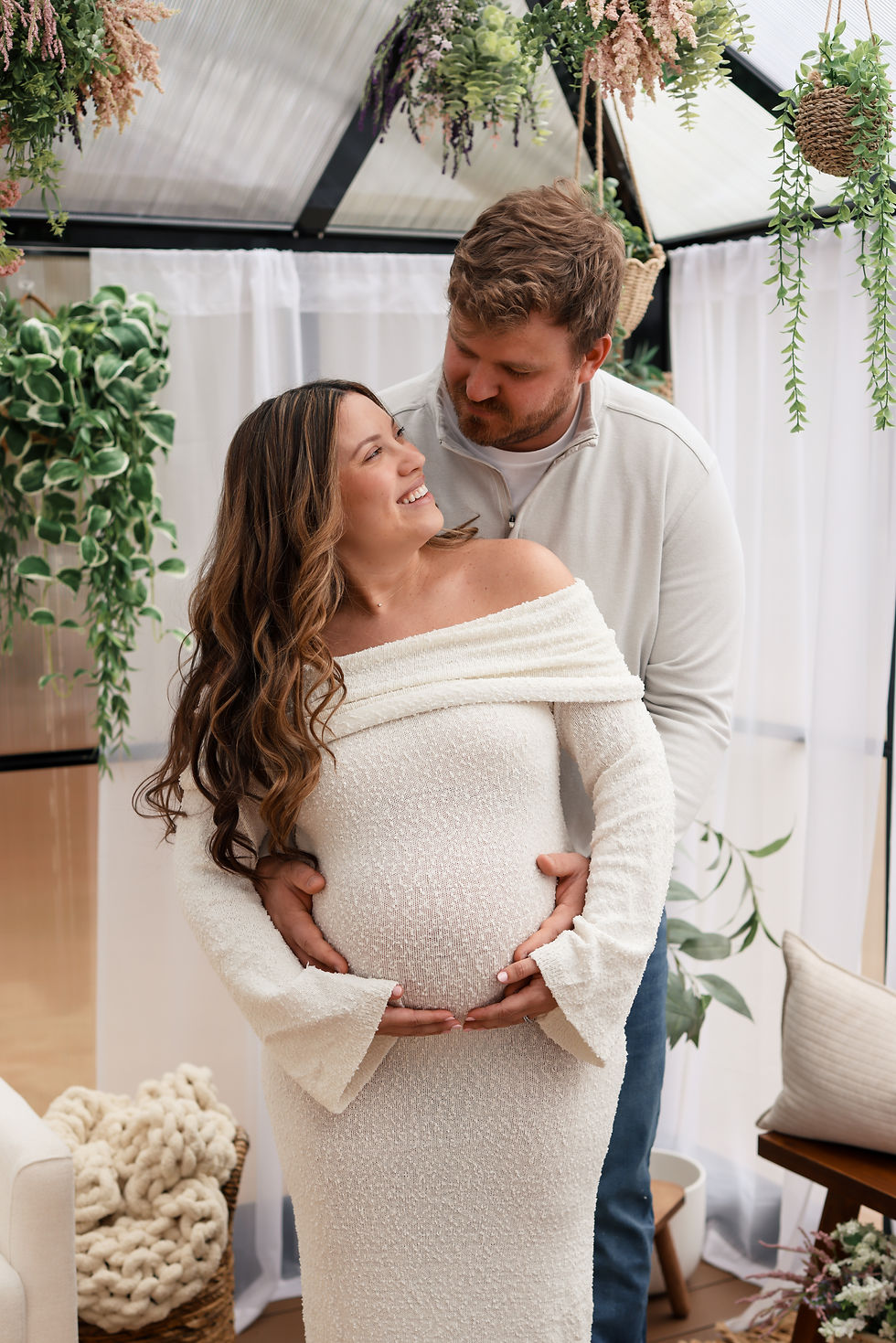 expecting mom lying in a window of a bright room