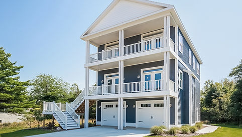 multi-story modern modular home with a beach house style