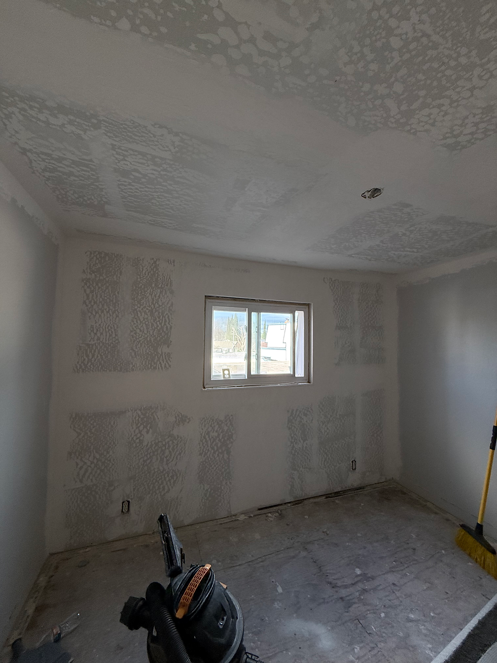 Small room under renovation with drywall installed on the walls and ceiling