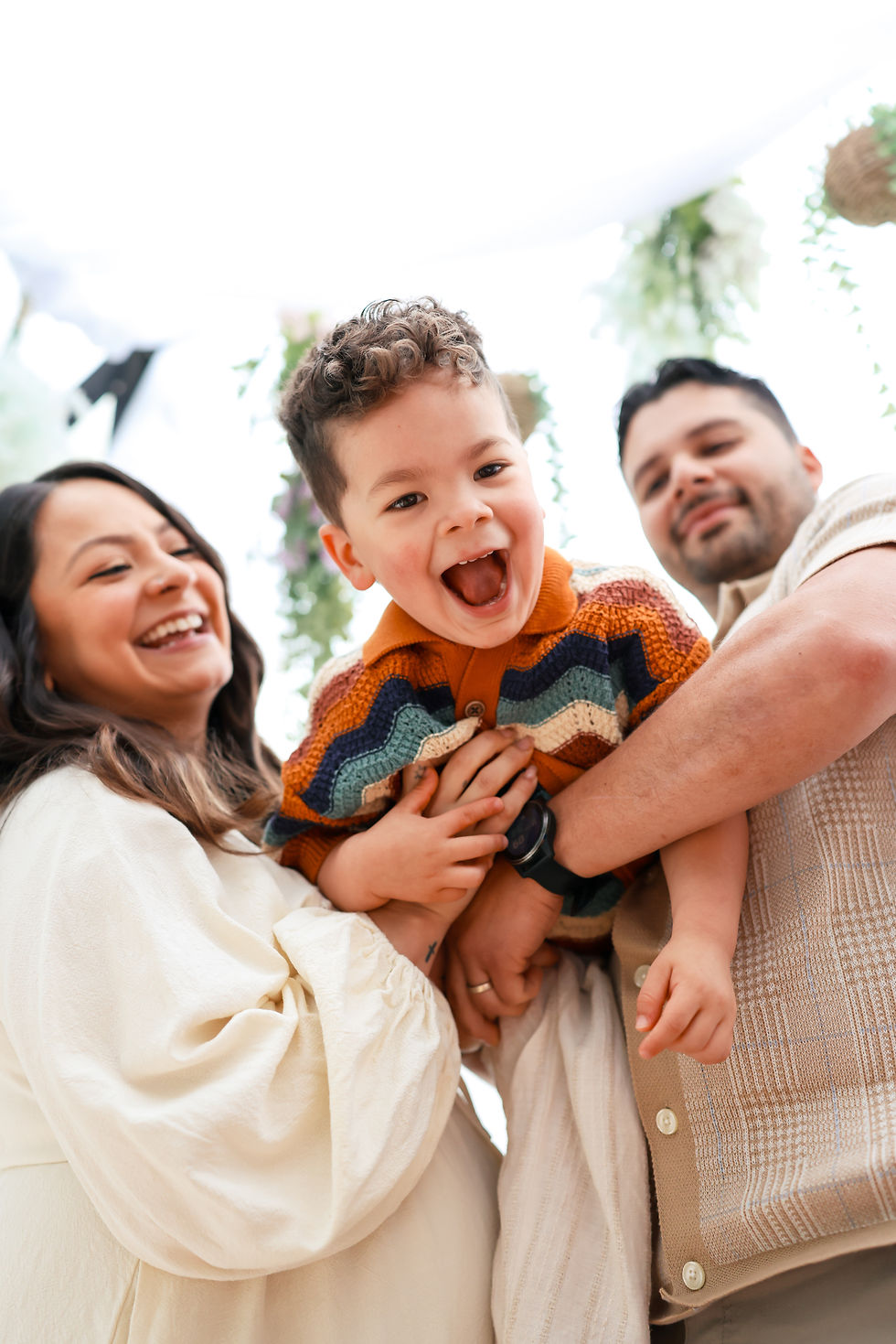 close up photo of couple looking at their kid