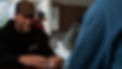 Man smiling while playing cards at Solutions Recovery Center.jpg