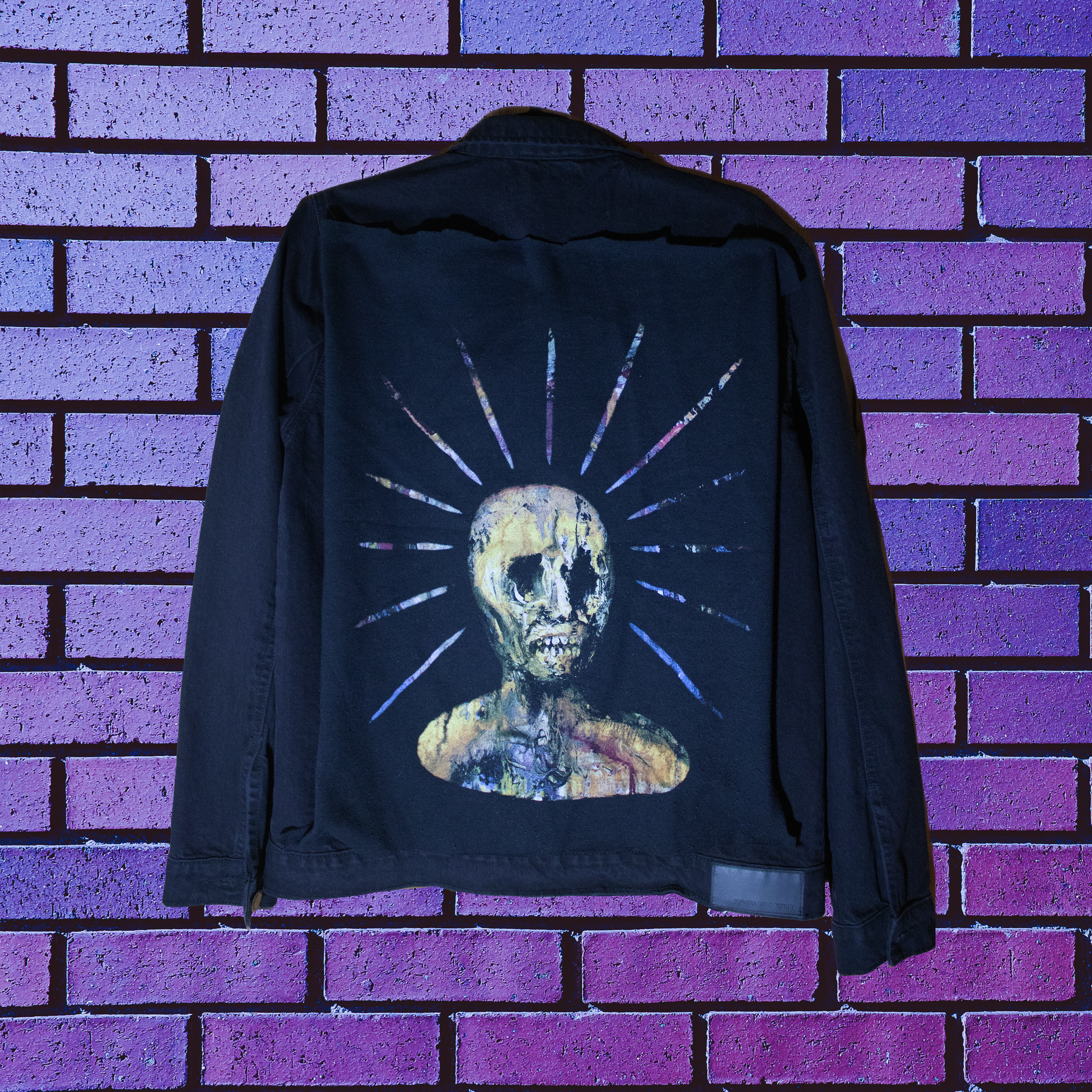 A custom made Demo'd black denim jacket featuring a black, yellow and purple back patch from the band End