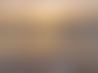 Ocean waves wash onto the shore under a glowing sunset sky, representing the flow of natural rhythms and inner balance. Megan Haggett created this image.