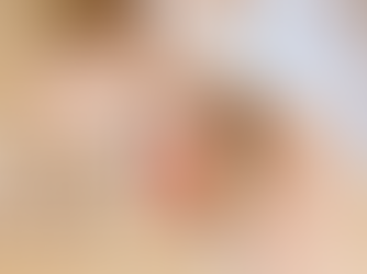 A person sitting cross-legged with a bowl of yogurt topped with granola and strawberries, symbolizing nourishment and honoring the body. Megan Haggett created this image.