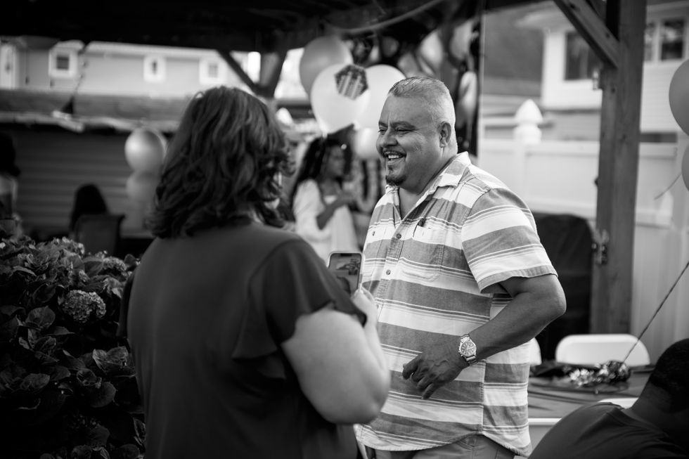 man smiles talking to woman 