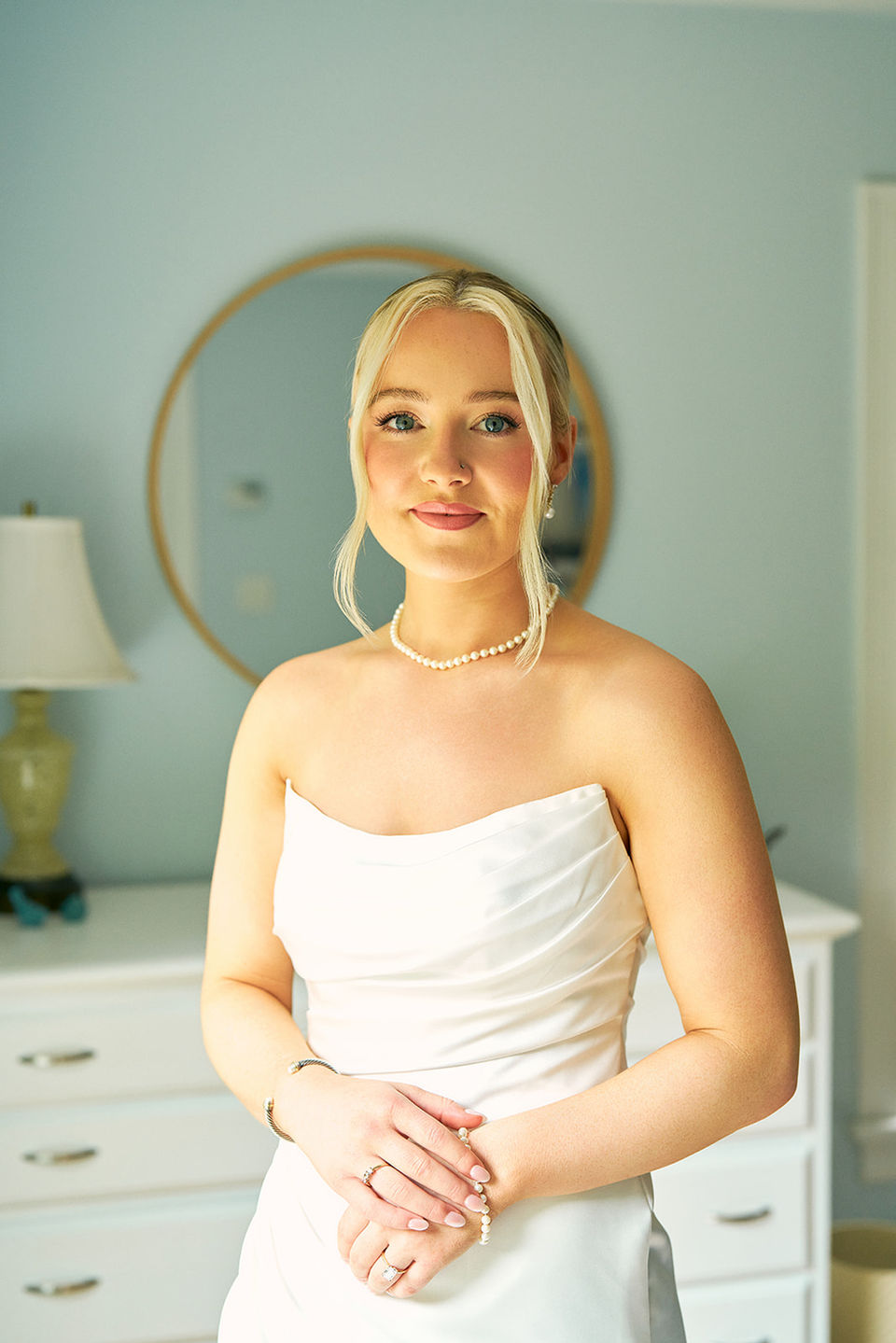 Portrait of a bride getting married in Cape Cod with soft glam makeup and a sleek bun hair style
