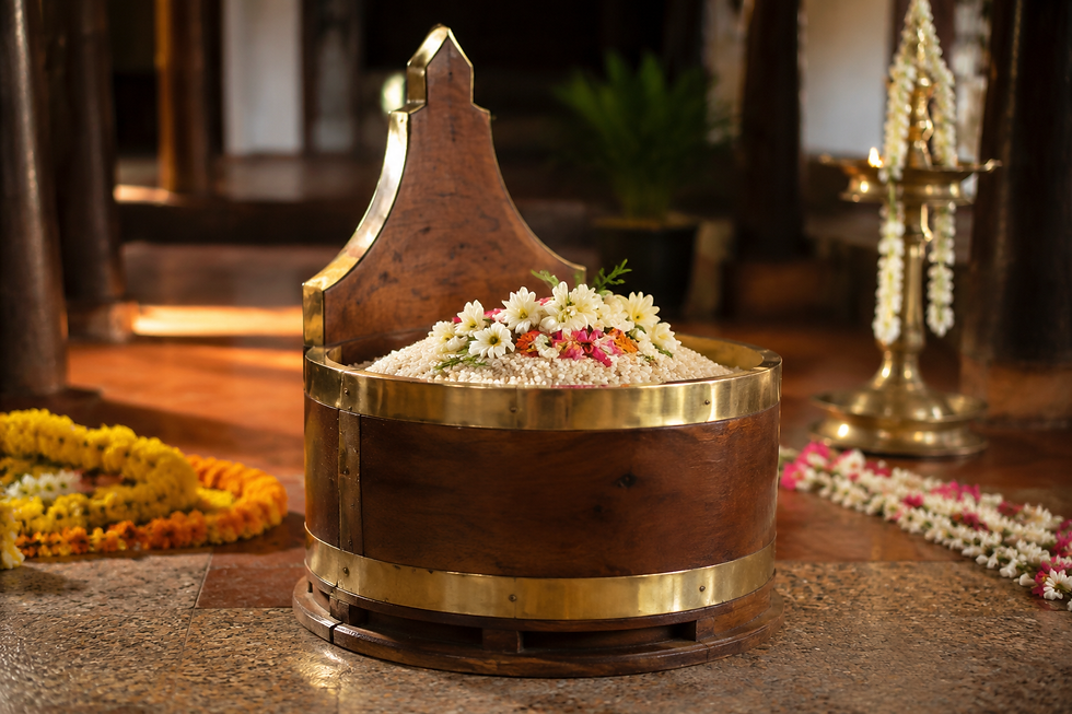 Handcrafted Kerala wooden nirapara with brass embellishments filled with rice and flowers