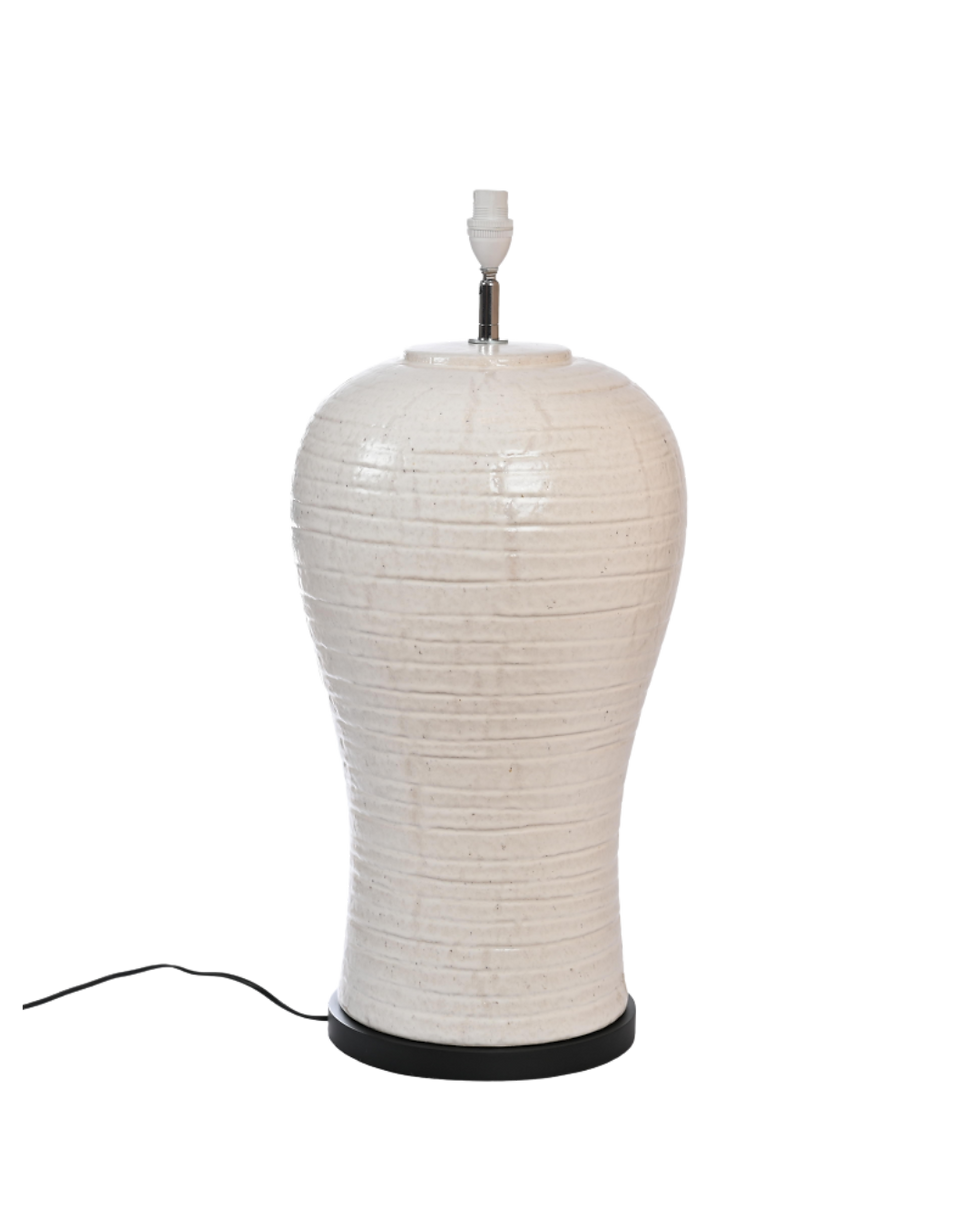 Table lamp with a textured, rough cream base and minimalist design, styled for modern and rustic interiors.