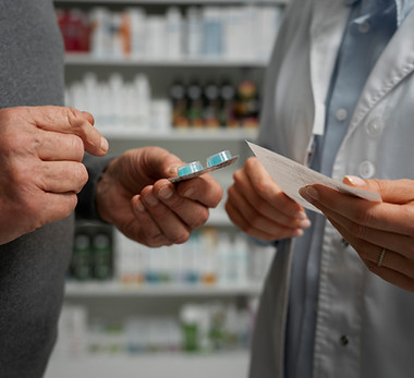 senior-man-consulting-female-pharmacist-medication (1).jpg