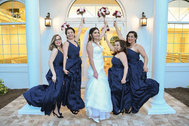 Bride and bridesmaids holding bouquets, happy smiles, Weddings, elegant venue, wedding.