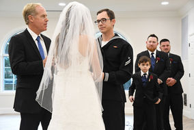 Bride and groom at wedding ceremony, surrounded by friends and family. Weddings