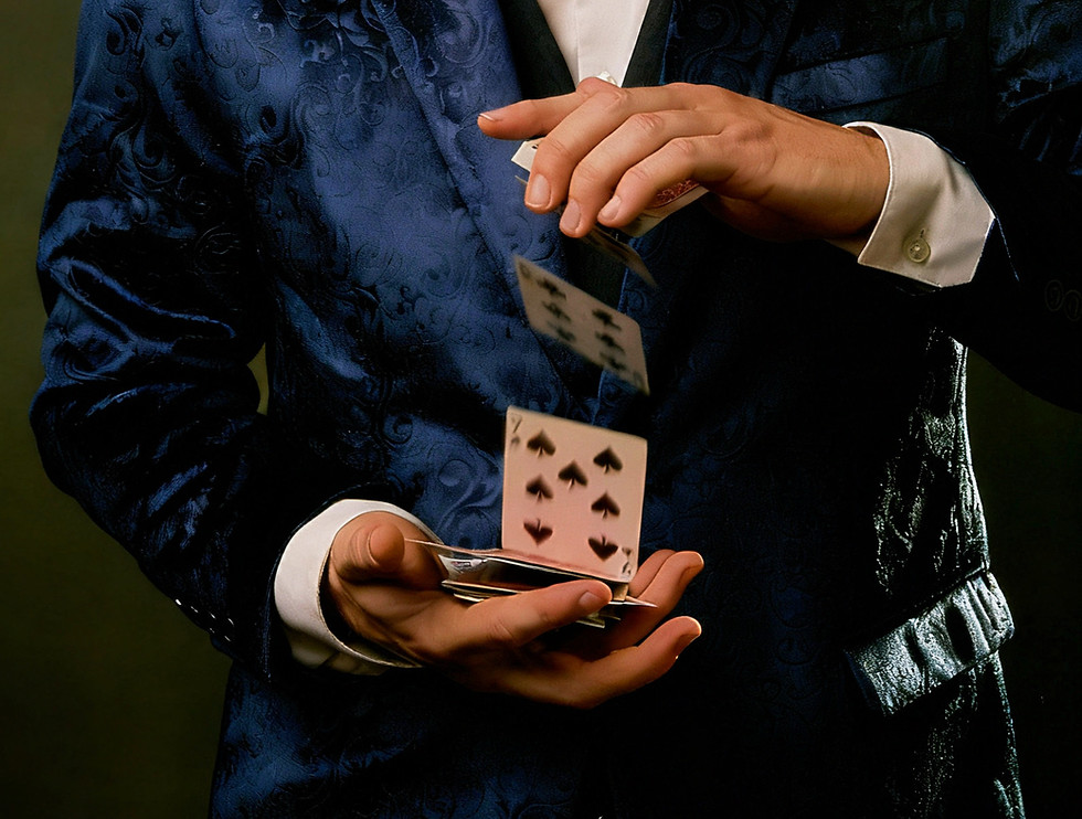 Zach Michel, comedy magician, performing a levitating card trick
