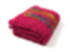 Side view of Magenta travel blanket with rich highlights