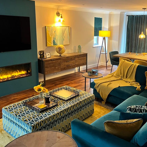 teal sofa and TV fireplace in lounge