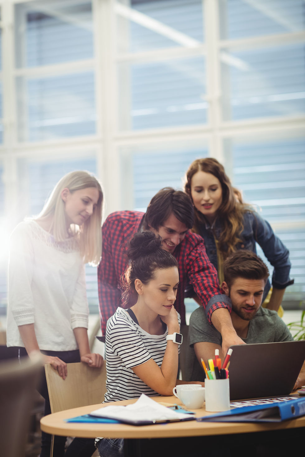 group-business-executives-discussing-laptop-their-des.jpg
