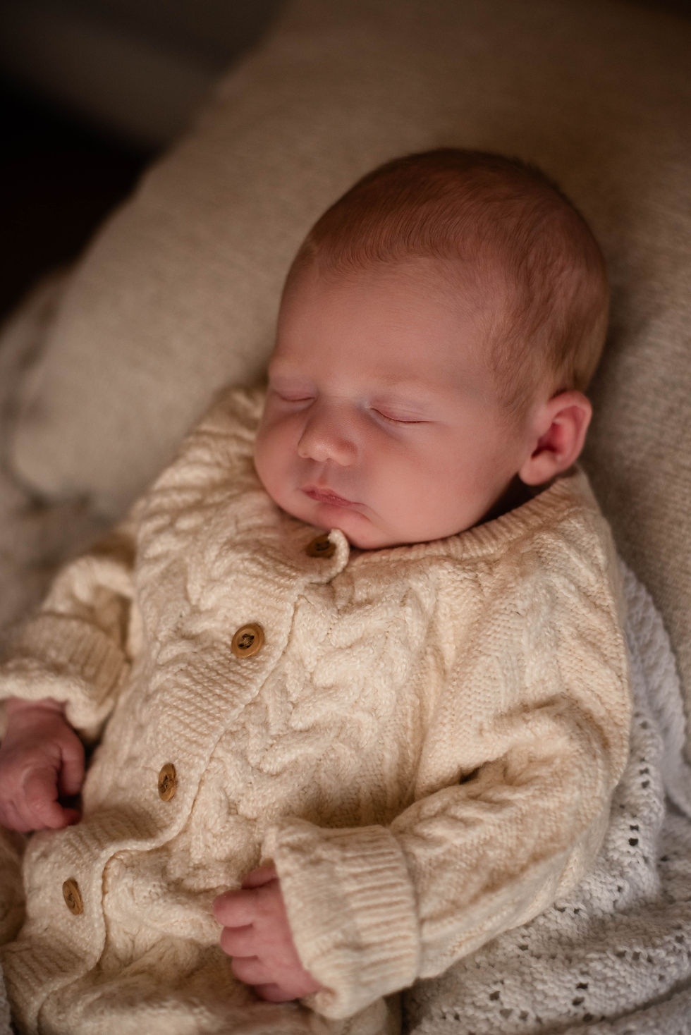 Baby fast asleep in wool jumper