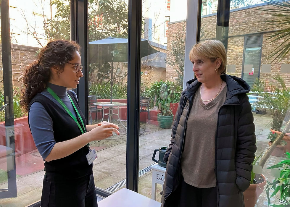 Two women in conversation in Mildmay's conservatory
