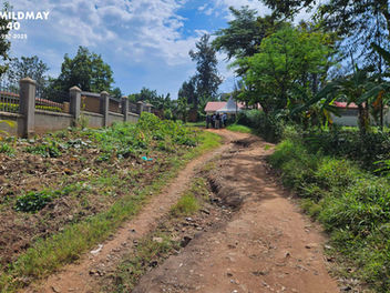 Mildmay team visiting the proposed health centre site in Mbale, Uganda, discussing access and gifted land with JOY Health Centre and Deliverance Church Mbale.