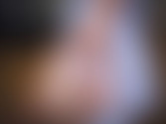 A nurse's hand reaches to grasp a patient's hand.