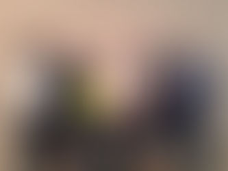 A group photo showing Mildmay CEO Geoff Coleman standing with six colleagues from Mildmay Uganda. They are smiling and standing in a row against a plain wall. Geoff is in the centre wearing a light shirt and vest; the others are dressed in smart professional attire. The image is marked with the “Mildmay at 40, 1985–2025” logo in the top left corner.