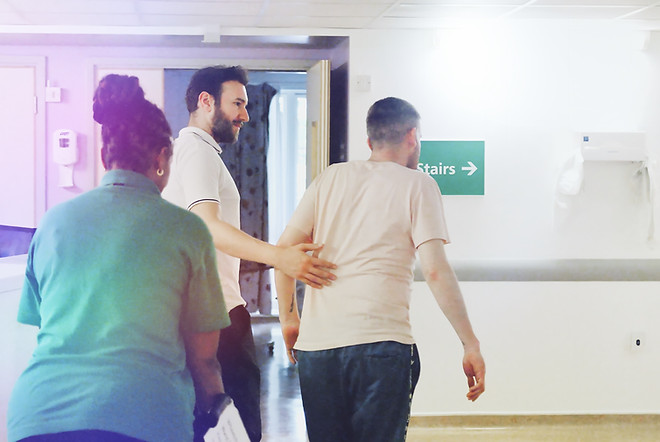 A patient in one of Mildmy's wards with two clinicians