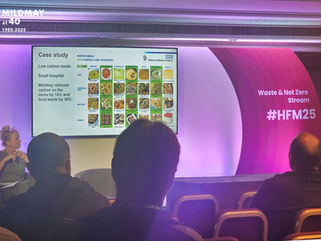 A seminar room with a PowerPoint slide on screen featuring Mildmay's patient menu