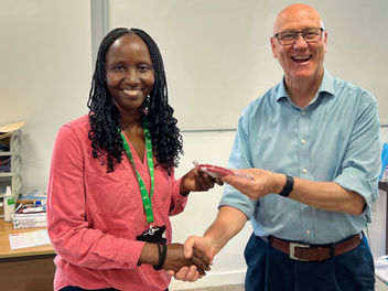 Justine receives her prize from CEO Geoff