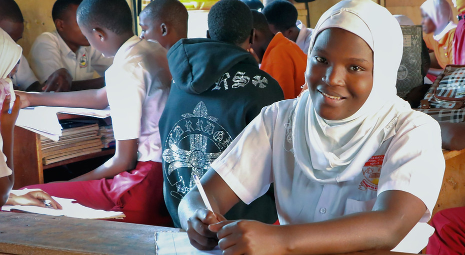 Samira at her school desk - a recipient of the Universal Fund