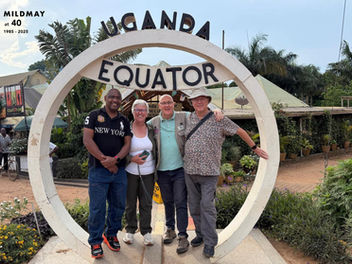 Mildmay Trustees and the CEO on a symbolic equator marker in Uganda