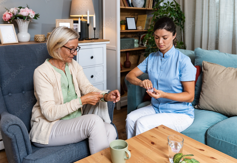Caregiver preparing medication for an elderly woman