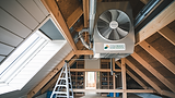 Whole house fan system inside attic.