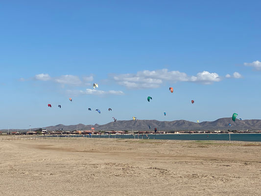 Beach full of kitesurfers during the windy season in Colombia, Cabo de la Vela