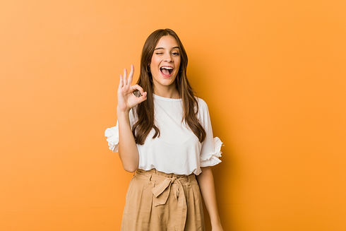 young-caucasian-woman-winks-an-eye-and-holds-an-okay-gesture-with-hand.jpg