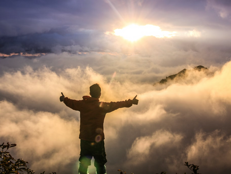 man in the mist looking at the sunset