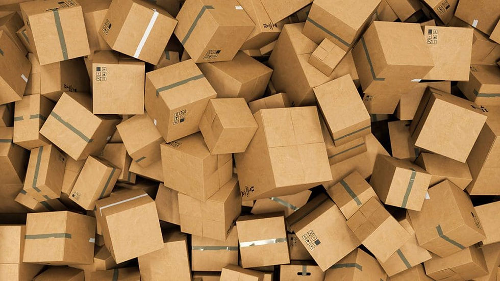 Pile of disorganized cardboard auto parts boxes representing excess inventory accumulation that reduces profit margins and creates idle stock problems.